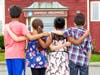 Children served by Family Promise MetroWest standing outside the Mulligan Street shelter. 