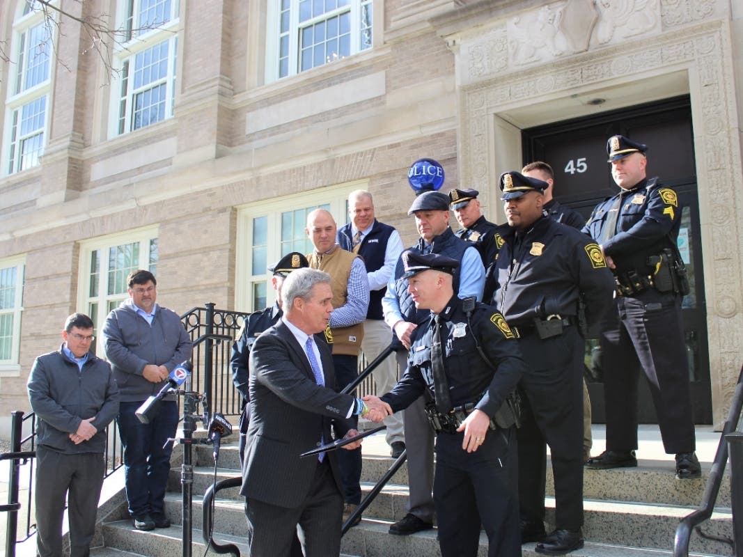 Worcester District Attorney Joseph Early Jr. (l) presenting Westborough officer John Sweeney (r) with a TEAM award.