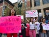 A group of demonstrators cheer at passing cars along Main Street in Worcester on Tuesday. 