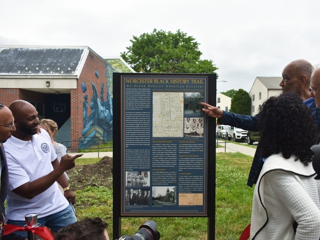 Holy Cross professor Thomas Doughton (r) points to the new Worcester Black History Trail marker at the corner of North Ashland and John streets. 