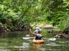 Rhode Island School of Design professor Emily Vogler waves goodbye as the kayak team departs Worcester. 