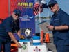 Members of Woods Hole Flotilla at a public affairs event promoting safe boating with a remote controlled boat named "Coastie"