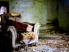 Photograph entitled, "Don't Take a Seat" Thomas Slatin 2016 - This photograph was taken in an upstairs room of an abandoned farm house, as photographed by Thomas W.P. Slatin. The vintage suitcase was sitting in the old chair. 