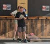 Wesley Cansler, 13, of Shelby Township, doing what he loves best, playing in a youth cornhole league, Monday night at One Eyed Jack's in Shelby Township. 