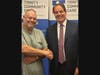 rinity Community Care patient Don McKinley bonds with Shelby Township Supervisor Rick Stathakis over like-minded interests during a patient and community partner recognition event at Trinity Community Care.