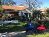 Audience relax and seat themselves safely for this outdoor concert. 