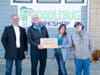 Kevin Williamson, president and COO, Compass Mortgage (2nd from left) receives a special plaque from Sarah Starke of DoodleBug Workshop. Compass senior loan office Jeff Kincaid is at far left and DoodleBug participant Alex Starke is at far right.
