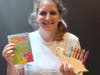 The kit includes a wooden Dino, crayons and activity book.