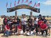 At the Oshkosh, WI Air Show, Project AMPLIFI students include Cole Anderson (1st row-3rd from R); back row: Wyatt Claar (4th from L), Levi Knapp (5th from L), Mark Thompson (center). Mentoring Mission's Carol Valentino-Barry is first row, far right.