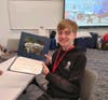 Cole Anderson displays his certificate after completing the 2026 Lewis University Aviation Career Education Academy.