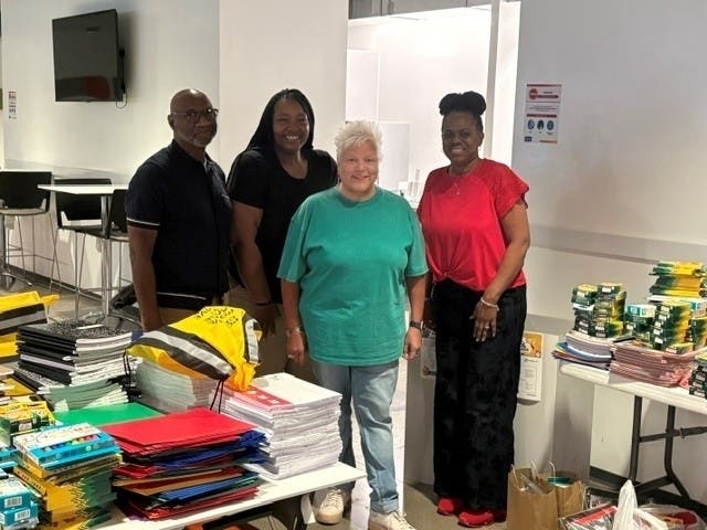 AutoNation Associates from the Corporate Office in Irving pose with donated school supplies