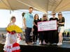 Victor Tanori, Sydney Thorp, and Arleyne Bishop of AutoNation present a $100,000 donation to Debbie Stantus and Chelsea Hemmons of Phoenix Children’s Foundation.