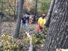 Elder Bly and Dan Anderson clearing debris and cutting up tree. 