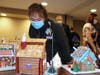 Ellie Kruk, chief nursing executive at Northwestern Medicine Palos Hospital, takes a peak inside a gingerbread house created by hospital staff at Northwestern Medicine Palos Hospital.