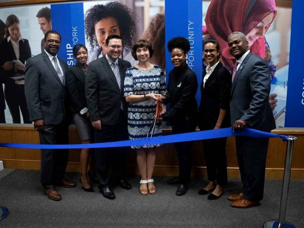 Dr. Duncan Harris, Capital Community College CEO (right), joins students and partners for the L.E.A.D. Center ribbon cutting.