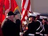 Shorewood Mayor Rick Chapman salutes as the U.S. Marine Corps Color Guard posts the colors to begin the Trinity Christian School Veterans Day Chapel.