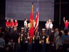 The U.S. Marine Corps Color Guard posts the colors as Trinity Christian School sixth graders sing the national anthem and seventh grader Amira Woods serves as the sign language interpreter.