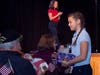 Trinity sixth grader Leah Stonitsch passes out gift bags to the veterans. The veterans received gift bags with thank you letters from approximately 240 students and gifts from local businesses. 