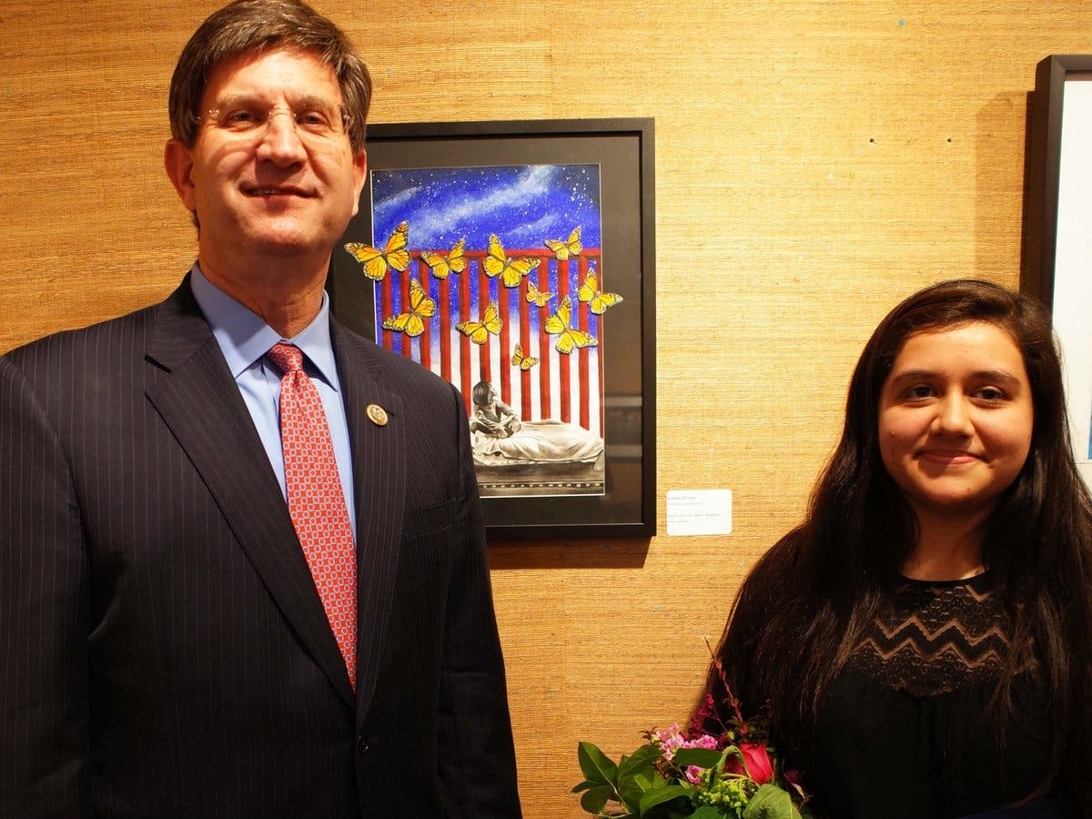 Brad Schneider and 2018 Congressional Art Contest winner Joselyn Duvon pose with her winning work.