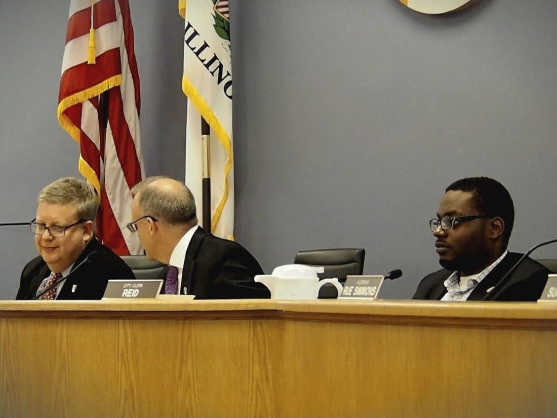 From left, City Manager Wally Bobkiewicz, Mayor Steve Hagerty, Clerk Devon Reid attend an Evanston City Council meeting.