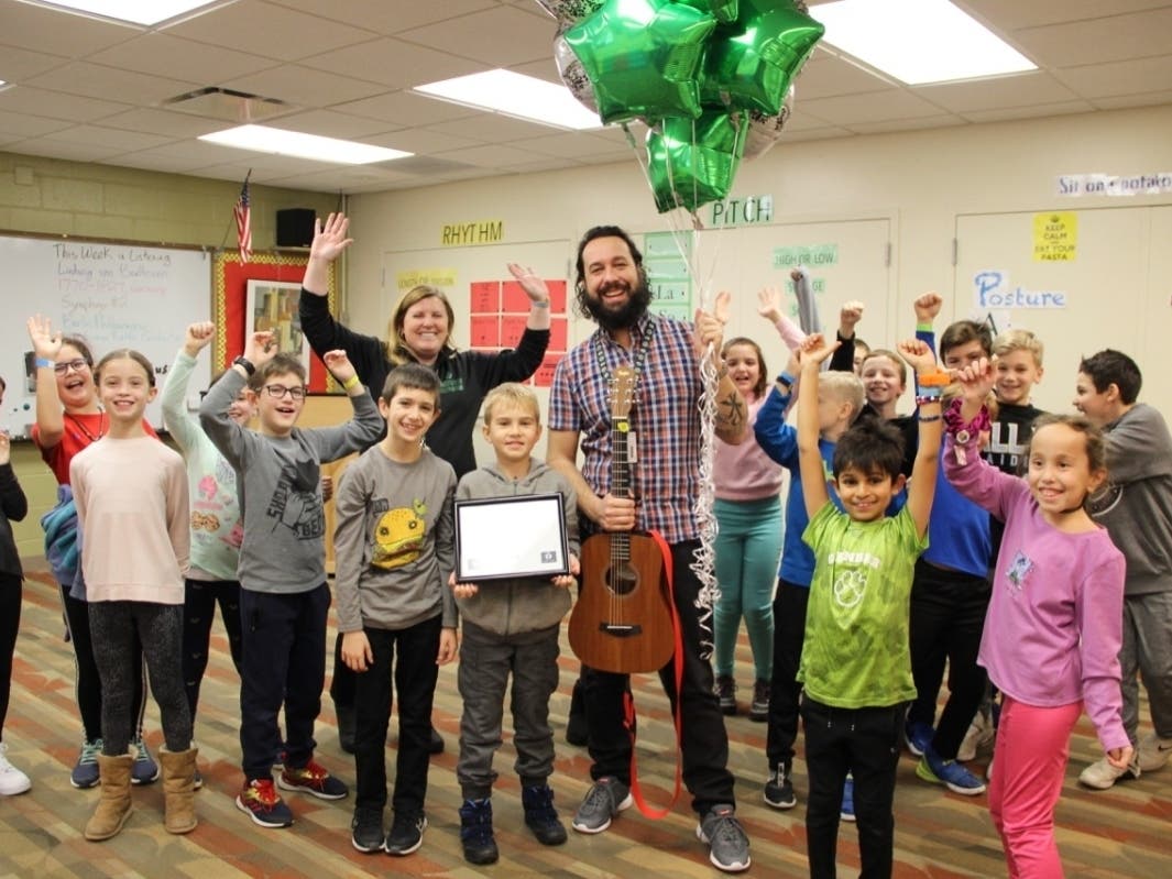 Greenbriar School Principal Dr. Ginny Hiltz and a class of students celebrate Mr. Jeremy Bartunek being selected as a Golden Apple Finalist for Teaching Excellence.