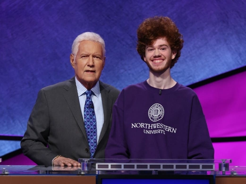 Alex Trebek, host of Jeopardy!, is pictured with Benji Keown, of Evanston, a contestant in the 2020 college tournament. 