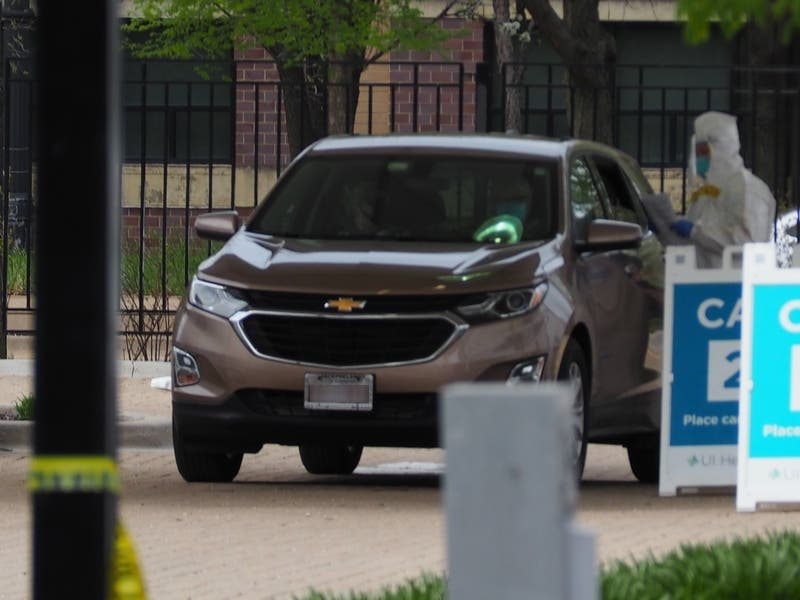 Staff at a drive-thru testing site operated by University of Illinois Hospital and Health Sciences System in Chicago collect samples to test for the coronavirus.