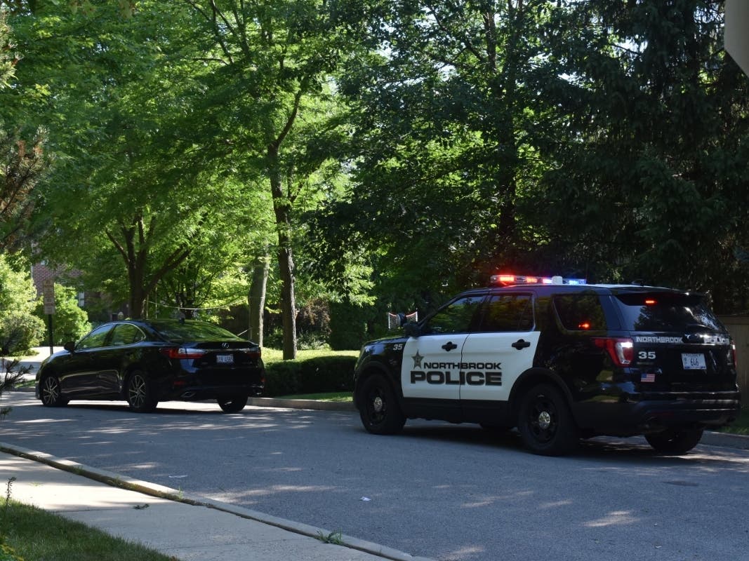 A Northbrook police car is pictured with a Lexus that prosecutors said Zayveon Thomas and two other unidentified accomplices drove to the Glencoe Golf Club before a botched carjacking Thursday.