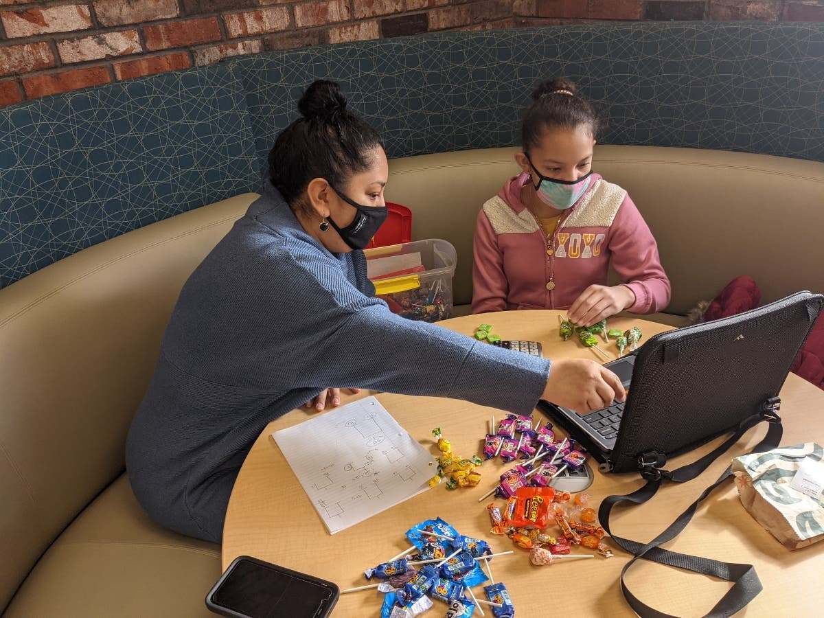 Highwood Youth Services Librarian, Diana Wence, helps a sixth grade student who recently arrived in the country with her family from Central America.