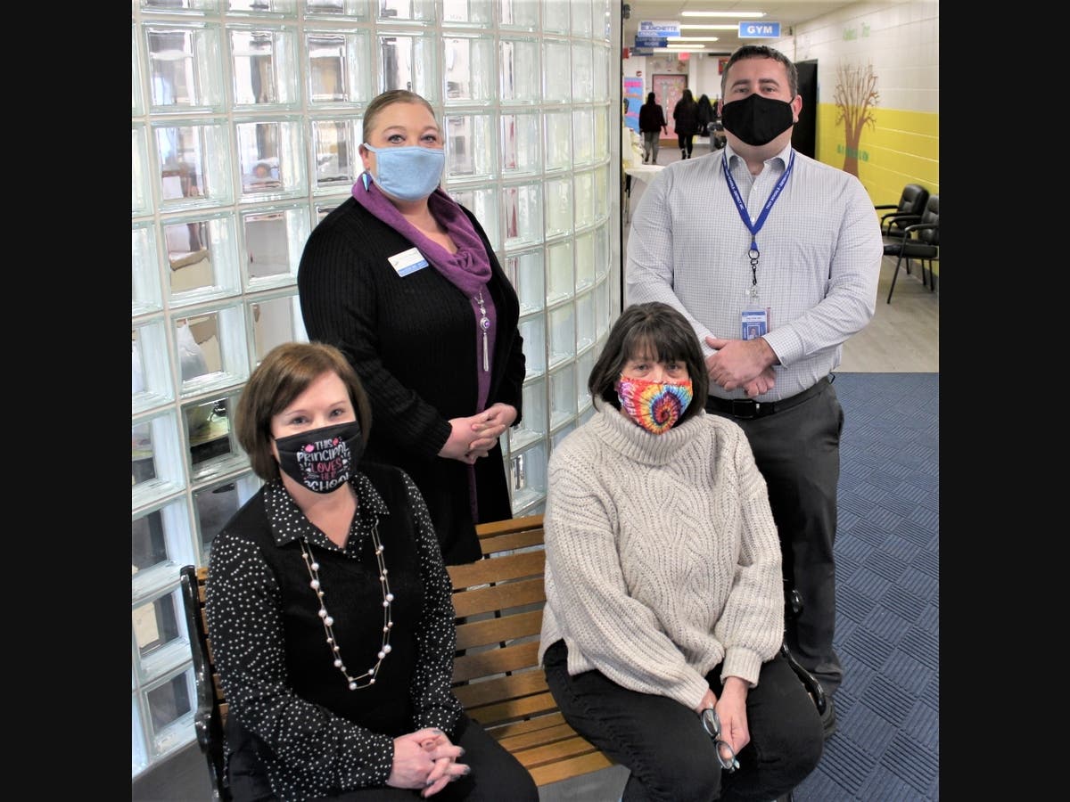 Clockwise from bottom left: Troy Shorewood Elementary School Principal Sherri Blanchette, Troy Shorewood Assistant Principal Danielle Wegner, Facilities and Operations Director Ben Hettel and retiring custodian Laurie Harrison. 