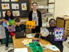 Troy Heritage Trail Elementary School students, here with art teacher Marisa Dion, show some of the favorite pieces they have created so far this school year.