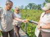 Longtime Mayslake volunteer steward Conrad Fialkowski (left) tours the Mayslake prairie he's worked to restore with Cindy Hedges, the Forest Preserve District's stewardship program coordinator, and Kathy Lech, District stewardship technician. 