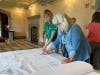 A Mayslake volunteer and a visitor discuss the project while looking at blueprints at the kickoff event on Saturday.
