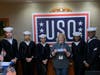 DAR member and USO volunteer Lynne Backer (center) presents a donation check from Signal Hill Chapter, NSDAR, and hosts Naval service men and women during their visit to the USO at O’Hare International Airport. 