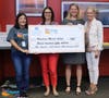 Woodland Middle Principal Dr Cindy Hall and Assistant Principal Michelle Kloese receive a grant check from EdExploreSRQ and the Community Foundation