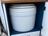 A Laveo portable waterless toilet conveniently stored inside a campervan.  