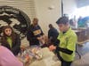 QUALITY CONTROL: Volunteers help check each bag making sure the right quantity of items are included in each snack bag.