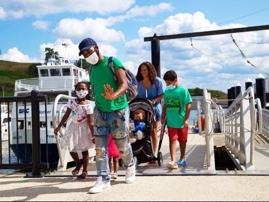 Family arriving at Spectacle Island. 