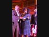 Gerami Groover-Flores, Executive Director of the Hamilton Garrett Music & Arts Academy, presenting the inaugural “Elta Garrett Educator of the Year” award to Fred Woodard, instructor, guitarist and Berklee College of Music graduate.