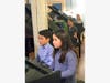 Students played simultaneously with two musicians at each piano.