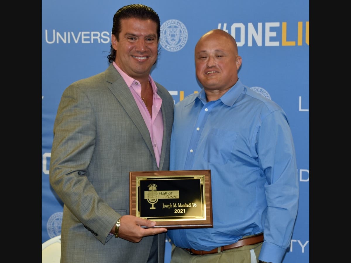 Peter Belotti, Jr., (right) CBS Sports radio producer, congratulates Joe Manfredi after introducing him as the newest member of The WCWP Hall of Fame.