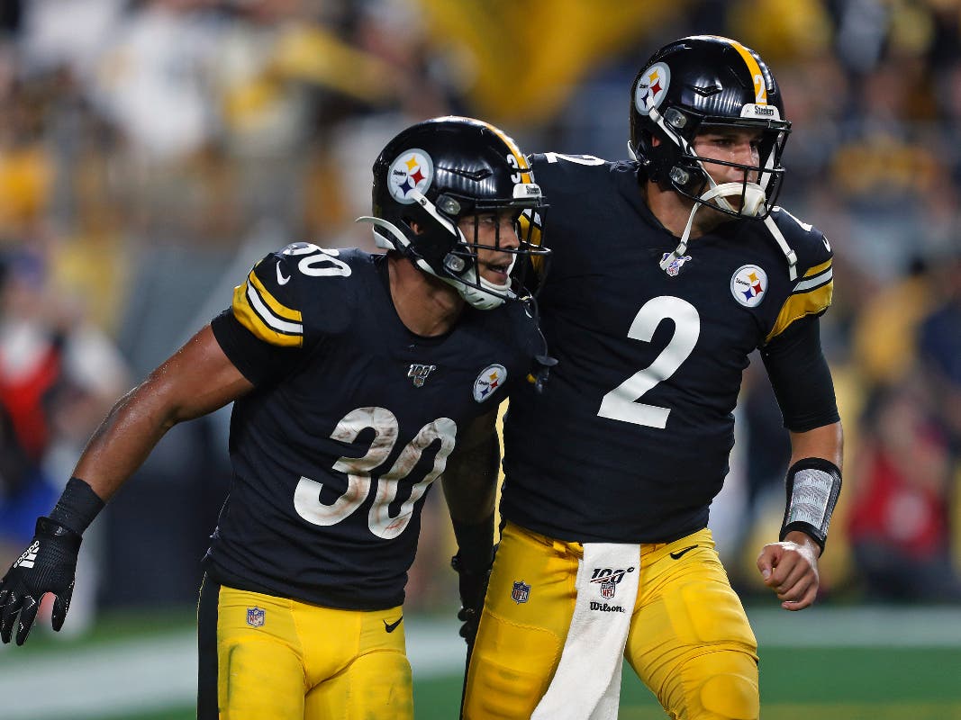 Pittsburgh Steelers running back James Conner (30) celebrates his touchdown with quarterback Mason Rudolph during the first half of an NFL football game in Pittsburgh, Monday, Sept. 30, 2019.