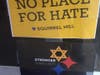 Signs in the window of a Squirrel Hill business.