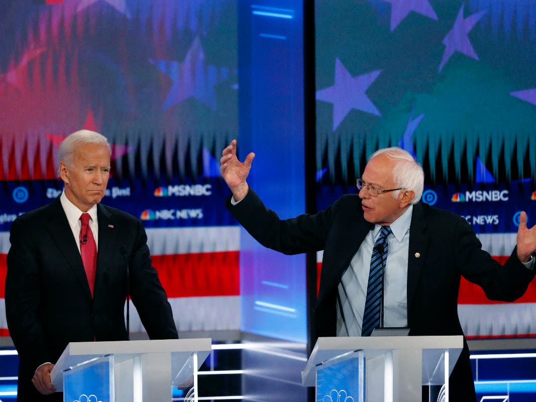 Democratic presidential candidate Sen. Bernie Sanders, I-Vt., speaks as Democratic presidential candidate former Vice President Joe Biden listens during a Democratic presidential primary debate, Wednesday, Nov. 20, 2019, in Atlanta.