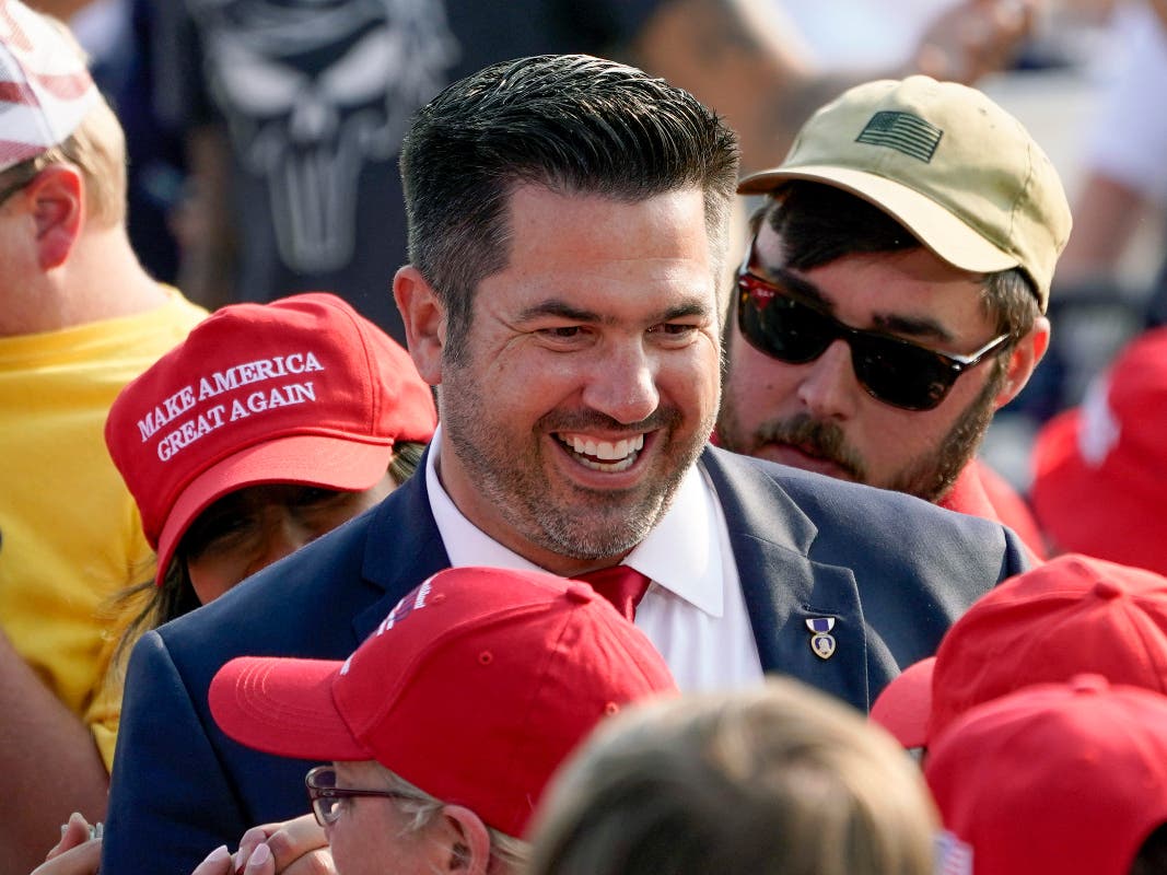 In this Sept. 22, 2020 file photo, Sean Parnell walks through people gathered at a campaign rally for President Donald Trump at the Pittsburgh International Airport in Moon Township, Pa.