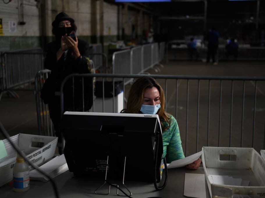 A Donald Trump campaign poll watcher films the counting of ballots at the Allegheny County elections warehouse last November in Pittsburgh.