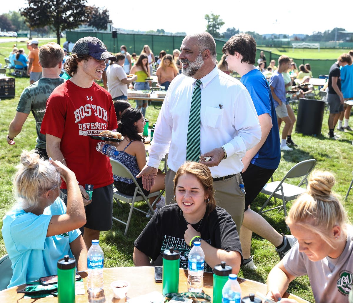 Slippery Rock University President William Behre chats with students at a campus cookout.