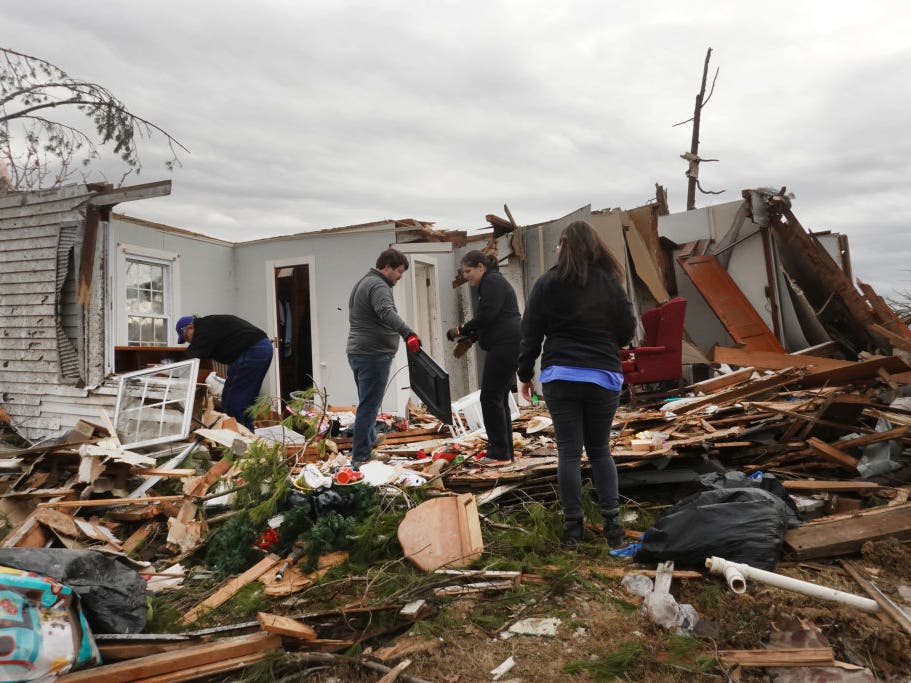 Residents search among the debris of a home after it was destroyed from Friday's tornado on December 15, 2021 in Dawson Springs, Kentucky.