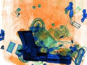An X-ray image of a firearm in a backpack.
