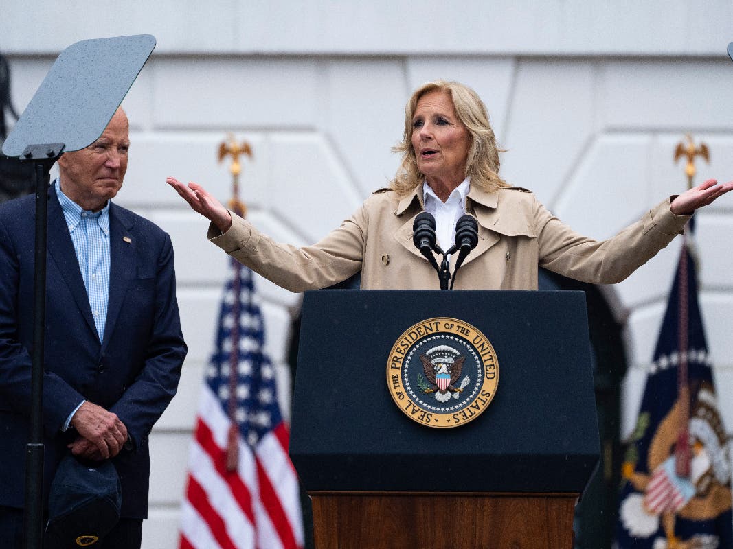 President Joe Biden listens as first lady Jill Biden speaks during a barbecue with active-duty military service members and their families on the South Lawn of the White House, Thursday, July 4, 2024, in Washington. 